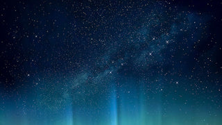 Aurora borealis lights dancing across a starry night sky.